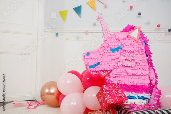 Fototapeta Bright party decor feature cheerful unicorn pinata and balloons