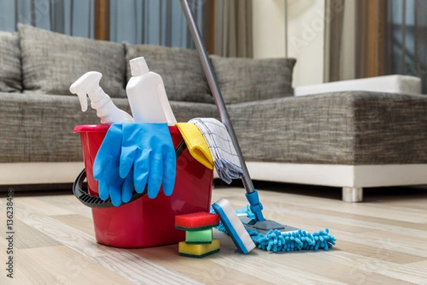 Fototapeta Cleaning service. Bucket with sponges, chemicals bottles and mopping stick. Rubber gloves and towel. Household equipment.