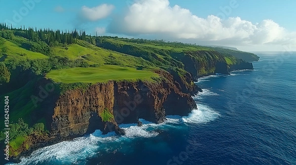 Fototapeta Coastal scene with cliffs a verdant golf course and ocean waves under a bright sky with scattered clouds
