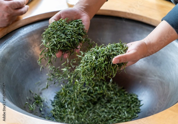 Fototapeta Traditional Chinese tea making techniques involve workers stir frying freshly picked green tea in iron pots