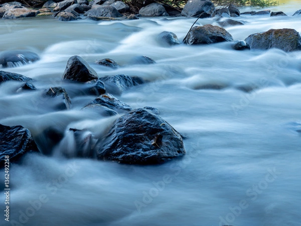 Fototapeta Serene River Flow with Rocks