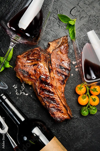 Fototapeta Bottled wine and Beef T-bone steak. Prime Black Angus beef steak and aged wine. Top view.
