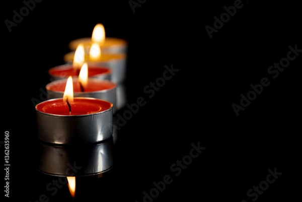 Obraz Several red scented candles against a black background