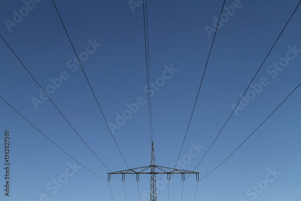 Obraz Electricity pylon on an overland route in Germany against a blue sky
