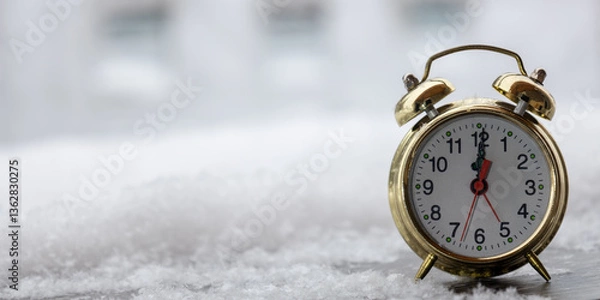 Obraz Golden alarm clock on a snowy winter backdrop.
