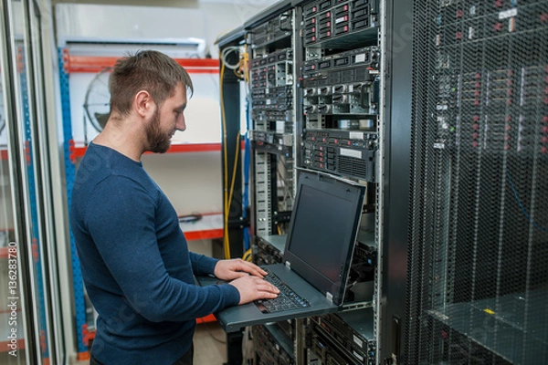 Fototapeta network engineer working in server room