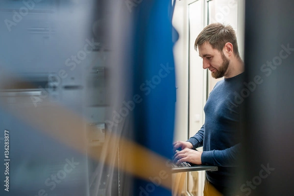 Fototapeta network engineer working in server room