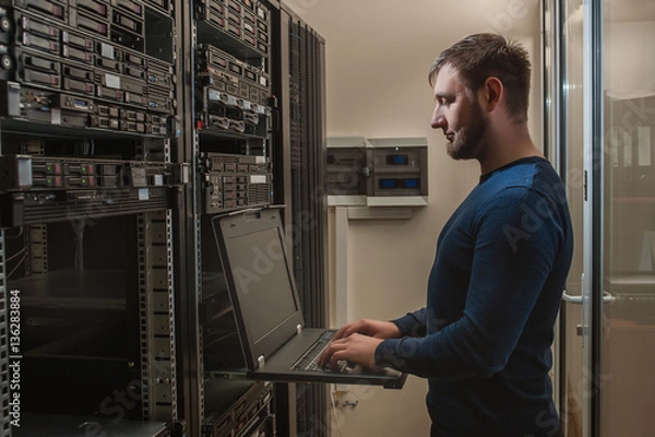 Obraz network engineer working in server room