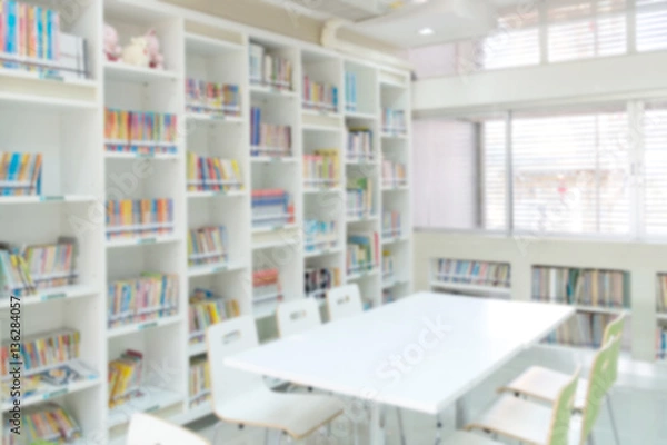 Obraz blurred bookshelf in library room for background