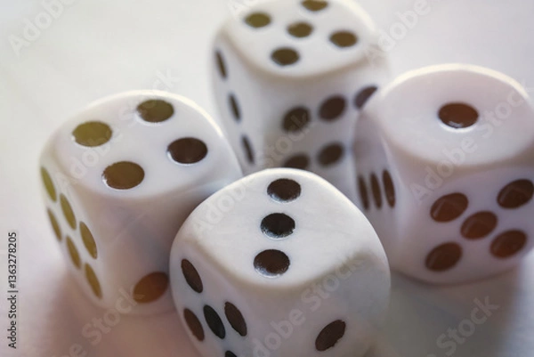 Obraz Four dices on a white table close-up