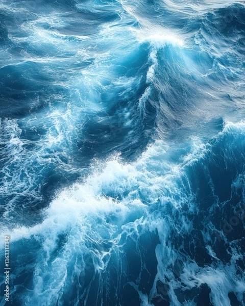 Obraz Aerial view of deep blue ocean waves crashing and foaming creating a dynamic seascape with a sense of vastness and power
