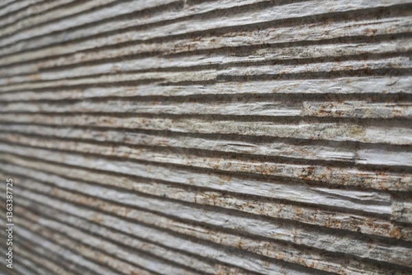 Obraz Rough, grooved stone wall background