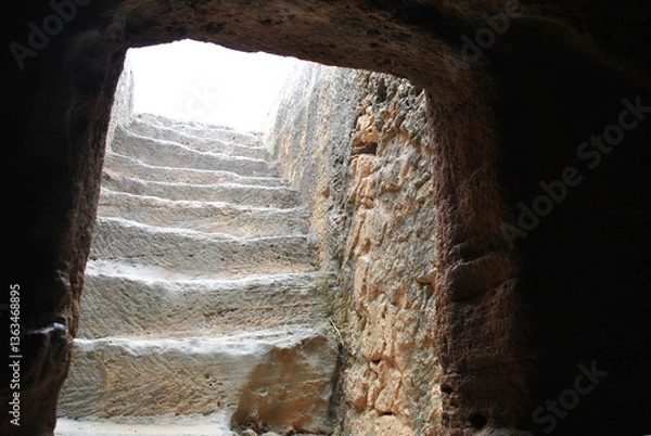 Fototapeta photo of old stone stairs running up towards the light