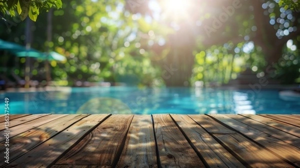 Fototapeta Swimming pool with a wooden deck in the middle of it, surrounded by lush greenery and trees in the background, Tropical background for your products presentation.