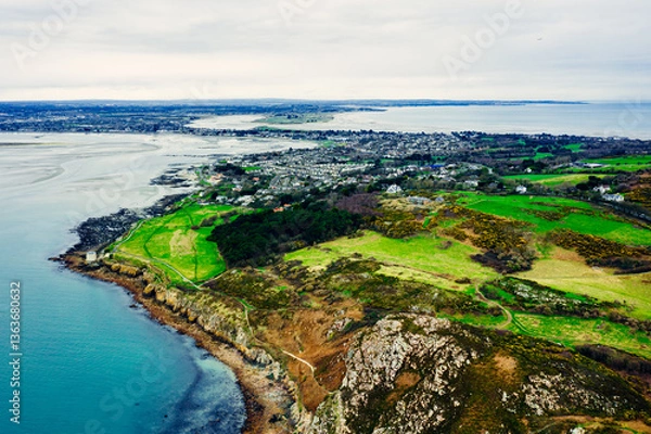Obraz Aerial Drone View of the Irish Rocky Coastline With Martello Tower in Howth – Cliffs, Blue Sea and Lush Greenery