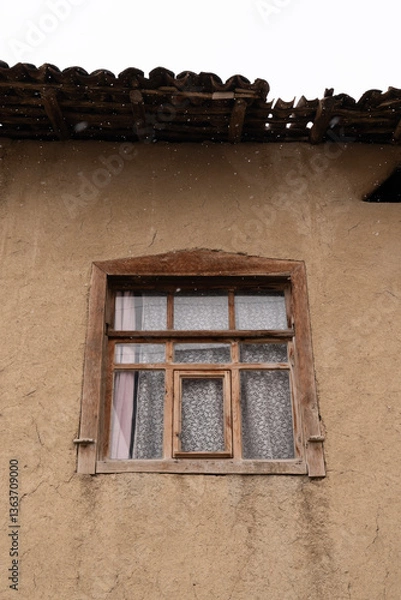 Fototapeta Weathered Wooden Window on a Rustic Wall in Snow