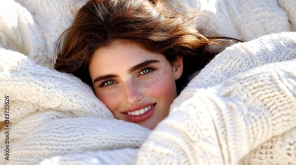 Obraz Woman smiling, nestled in cozy white knit sweater.