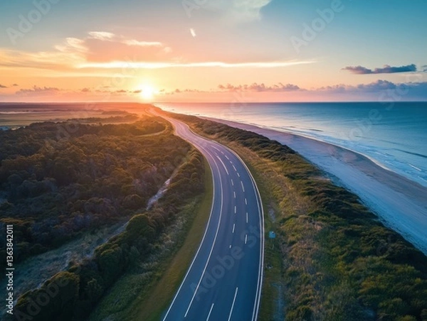 Fototapeta Aerial coastal highway at sunset with drone perspective and negative space on left