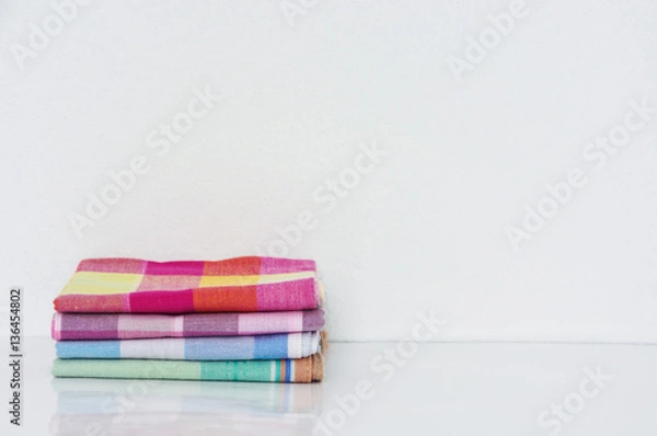 Fototapeta stack of folded handkerchiefs on white background, copy space