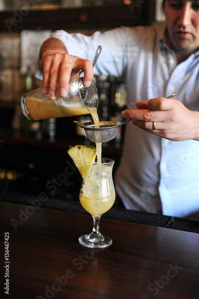 Obraz Bartender poring a cocktail