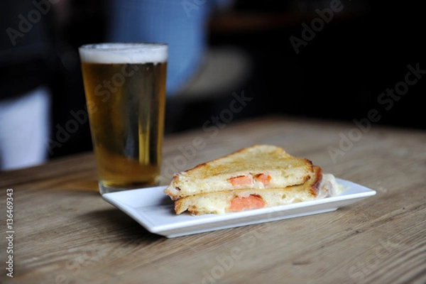 Obraz Grilled cheese and beer at a bar for lunch
