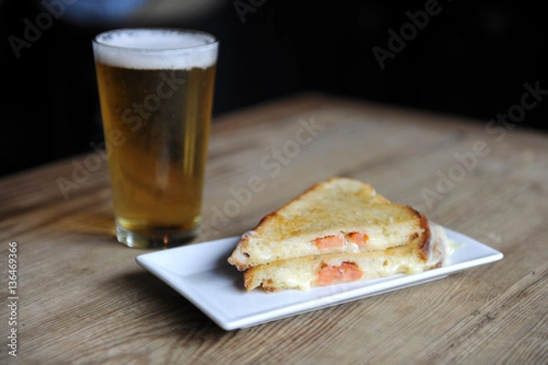 Obraz Grilled cheese and beer at a bar for lunch