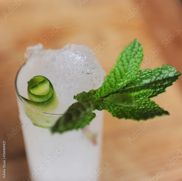 Obraz Refreshing cocktail with mint garnish at a bar
