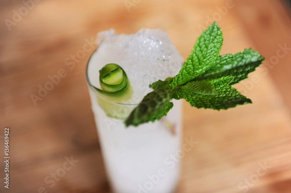 Obraz Refreshing cocktail with mint garnish at a bar
