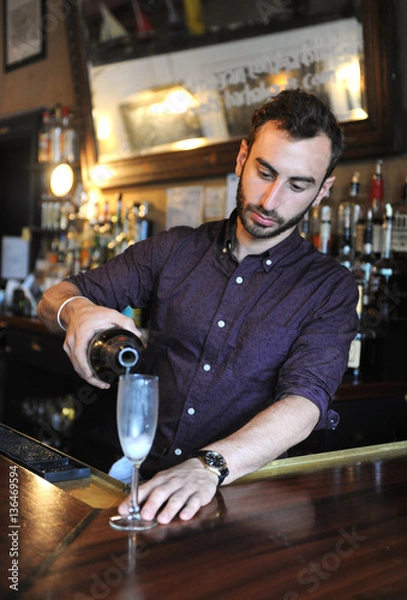 Obraz Bartender pouring champagne