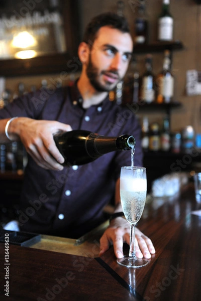 Obraz Bartender pouring champagne