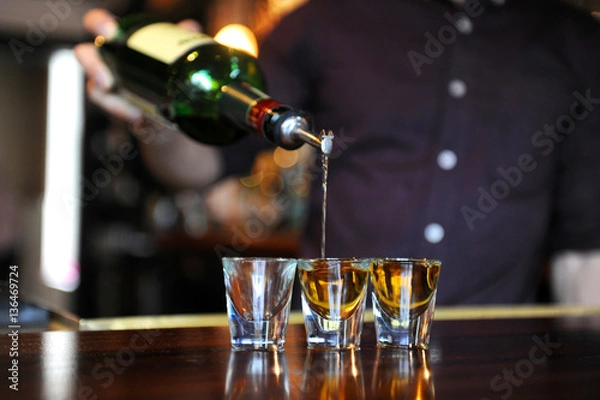Obraz Bartender pouring shots