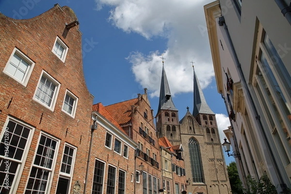 Obraz Traditional historic medieval houses, located in the neighborhood Bergkwartier of Deventer, Overijssel, Netherlands, with the two towers of Saint Nicholas church