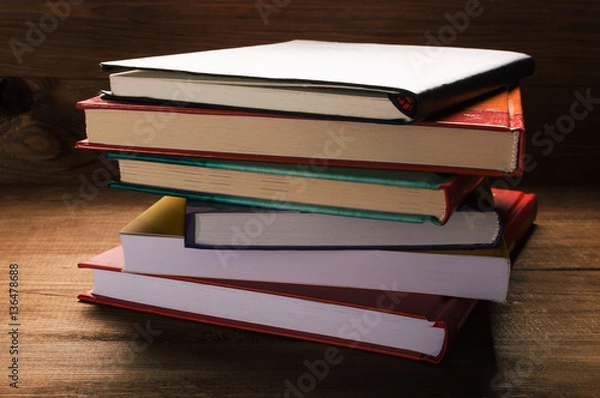 Fototapeta Stack of books on the wooden table