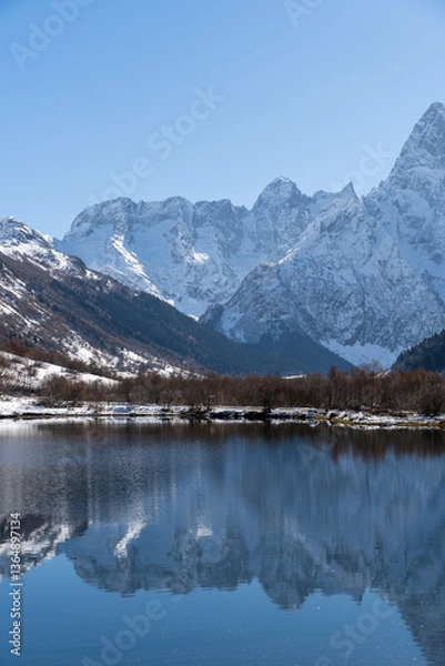 Fototapeta Dombay, Karachay-Cherkessia. Teberda National Park. Lake Tumanly-Gel or Tumanly-Kol (Misty Lake) is in valley of Gonachkhir River. Snowy peaks of Mount Chotcha are reflected in lake as in mirror.