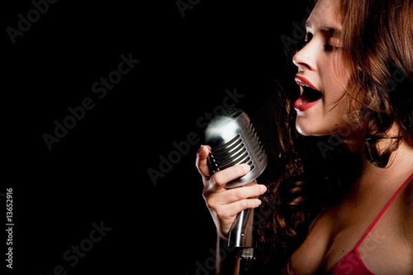 Fototapeta Beautiful singer singing with microphone