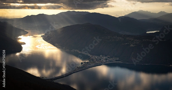 Obraz Golden Sunset Light Reflecting Over the Serene Waters of Lake Lugano Surrounded by Majestic Mountains
