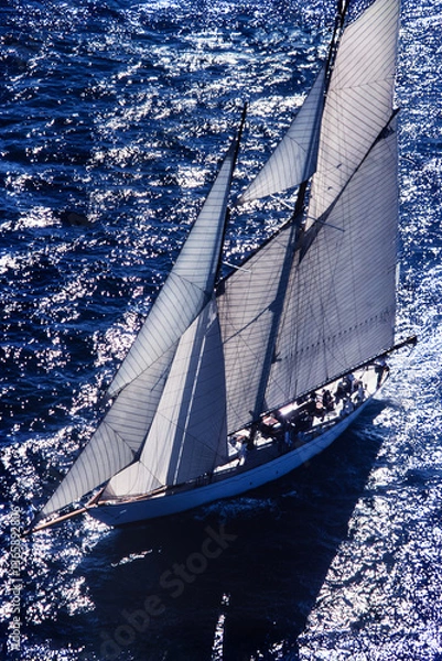 Fototapeta Flight over classic yacht sailing regatta in mediterranean coastal setting.