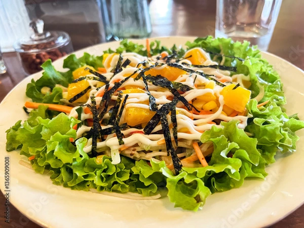 Fototapeta Kani salad with crab, fresh lettuce and mango with vegetables on a plate
