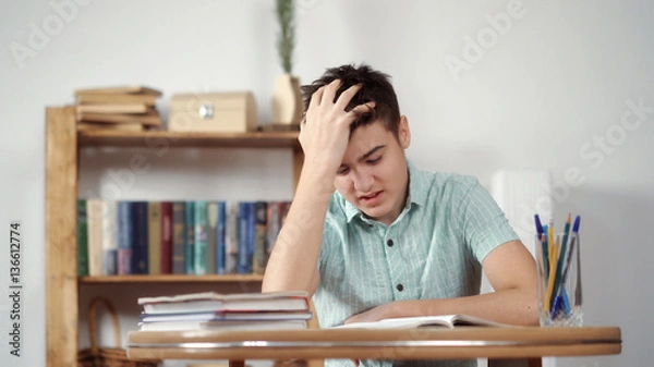 Obraz Upset schoolboy doing homework