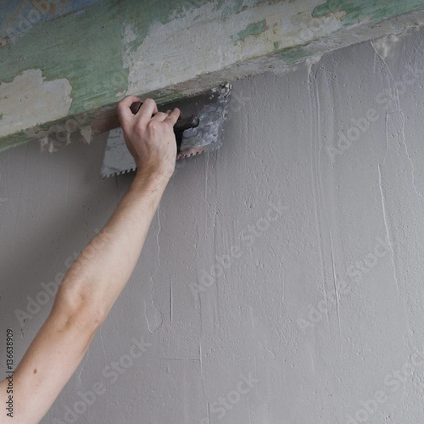 Obraz Hands Plasterer at work. Application of the plaster on the wall.