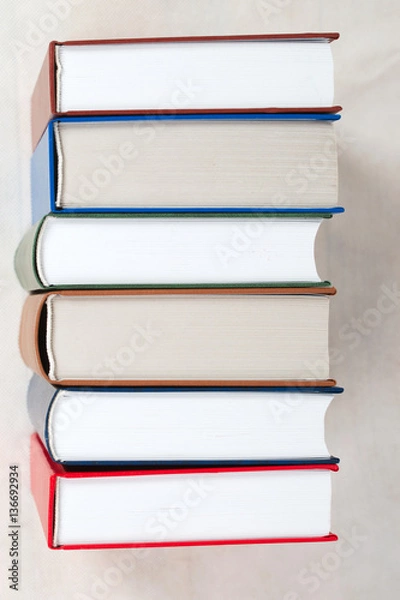 Obraz Stack of hardback books on table. Top view.