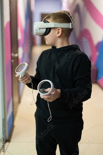 Fototapeta a child in virtual reality glasses plays a game