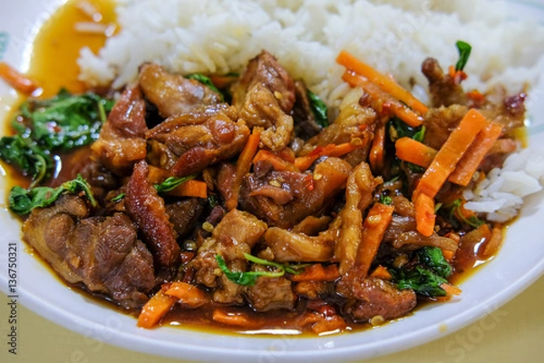 Fototapeta Rice topped with stir-fried pork and basil.