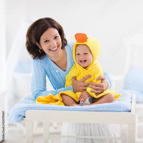 Fototapeta Mother and baby in towel after bath