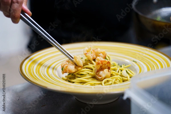 Obraz Chef plating shrimp pasta with precision