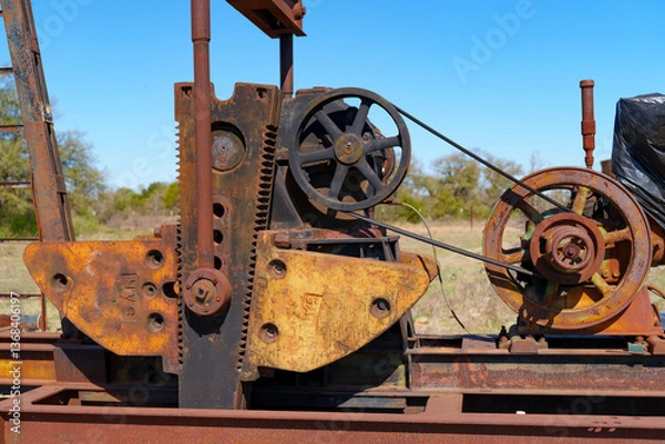 Obraz Idle, rusty oil well pumping equipment abandoned in field in West Texas.