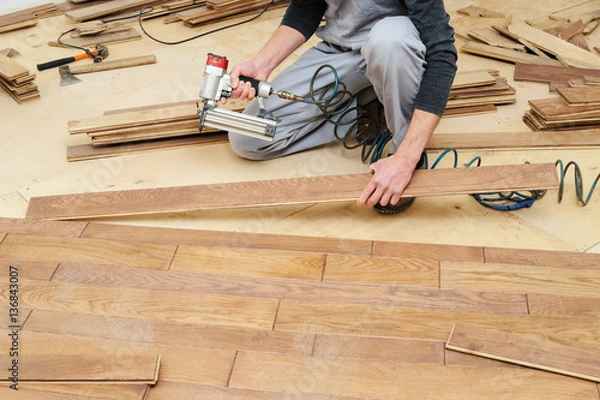 Fototapeta Installing a wooden floor.