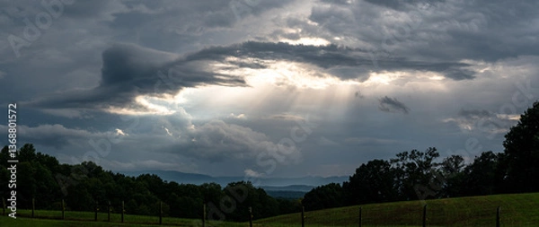 Fototapeta The Welcome Sunlight Breaking Through the Parting Storm Clouds