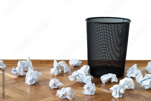Obraz Empty wastepaper basket surrounded by crumpled documents