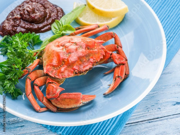 Fototapeta Cooked crab with lemon and herbs.